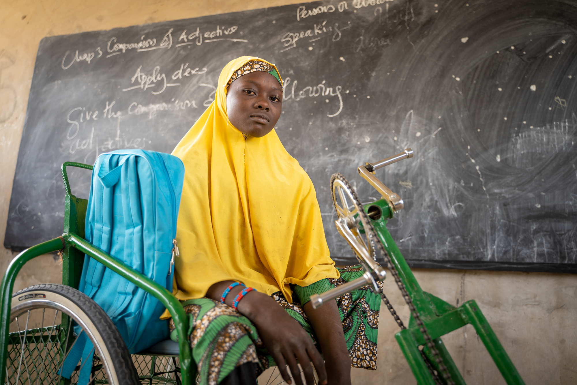 Young refugee girl sitting in her wheelchair.